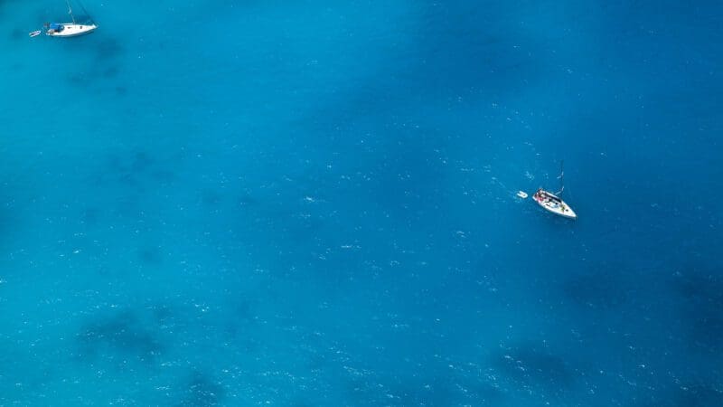 Boats on sea - top view with a lot of blue copy space
